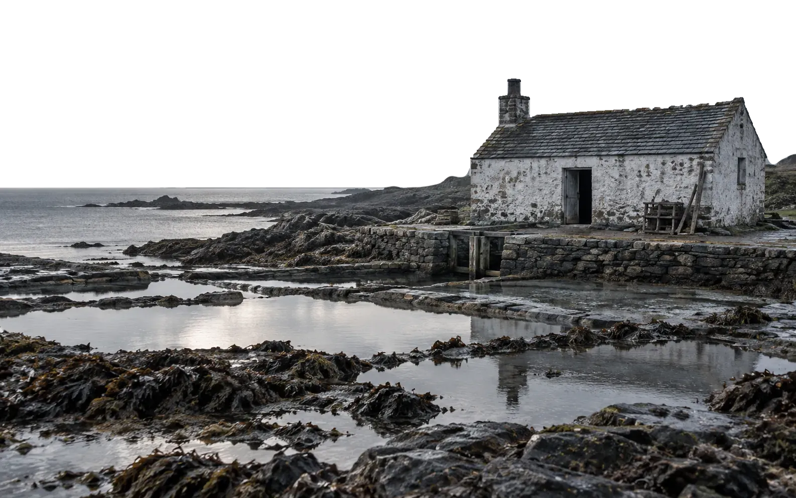 The stone salt works at Scarra Point at low tide, with rock pools and kelp in the foreground